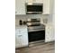 Close up shot of the kitchen with stainless steel appliances and white cabinets at 2242 Eldridge Rd, Newton Grove, NC 28366