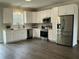 Well-lit kitchen with stainless steel appliances, white cabinets, and sleek countertops at 2242 Eldridge Rd, Newton Grove, NC 28366