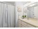 Bright bathroom with white vanity, large mirror, and stylish shower curtain at 2513 Boothbay Ct, Raleigh, NC 27613