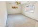 Spacious bedroom with neutral carpet, ceiling fan, a large window providing plenty of natural light at 2513 Boothbay Ct, Raleigh, NC 27613