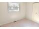 Bright bedroom with neutral walls, carpet flooring, and a window overlooking the yard at 2513 Boothbay Ct, Raleigh, NC 27613