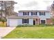 Charming two-story home with light blue siding, black shutters, and a well-maintained front yard at 2513 Boothbay Ct, Raleigh, NC 27613