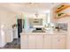 Well-lit kitchen with a mix of white and stainless steel appliances, granite counters, and hardwood flooring at 2513 Boothbay Ct, Raleigh, NC 27613
