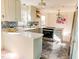 Bright kitchen with an island, light cabinetry, quartz countertops, and a stylish backsplash at 2513 Boothbay Ct, Raleigh, NC 27613