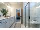 Bright bathroom featuring a double sink vanity, walk-in shower with seating, and ceramic tile floors at 275 Deodora Ln, Cameron, NC 28326