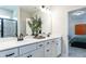 Bathroom featuring double sink vanity with black hardware and a glimpse into the bedroom at 275 Deodora Ln, Cameron, NC 28326