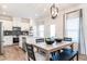 Bright kitchen open to dining space, featuring stainless steel appliances, granite countertops, and white cabinets at 275 Deodora Ln, Cameron, NC 28326