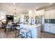 Bright kitchen with stainless steel appliances, granite countertops, white cabinets, stools at the breakfast bar, and open to the dining room at 275 Deodora Ln, Cameron, NC 28326