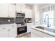 Well-lit kitchen features stainless steel appliances, quartz countertops and dark subway tile backsplash at 275 Deodora Ln, Cameron, NC 28326