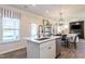 Modern kitchen boasts a large island with quartz countertops and stainless steel appliances at 275 Deodora Ln, Cameron, NC 28326