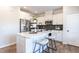 Well-lit kitchen with stainless steel appliances, granite countertops, white cabinets, and stools at the breakfast bar at 275 Deodora Ln, Cameron, NC 28326