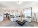 Inviting living room with two sofas, a stylish rug, a black coffee table, and an adjacent kitchen and dining area at 275 Deodora Ln, Cameron, NC 28326