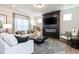 Cozy living room features a sleek fireplace, comfortable seating, and plenty of natural light creating an inviting atmosphere at 275 Deodora Ln, Cameron, NC 28326