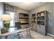 Chic home office featuring gray walls, modern desk, built-in bookshelf and neutral decor at 275 Deodora Ln, Cameron, NC 28326