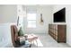 Comfortable sitting area featuring natural light, plush chair, and convenient storage at 275 Deodora Ln, Cameron, NC 28326