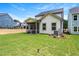 View of the back of the home showcasing the lawn, screened porch, and partial house siding at 301 Beacon Dr, Pittsboro, NC 27312