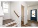 Welcoming entryway features hardwood stairs, white walls and trim, and a vibrant blue door at 301 Beacon Dr, Pittsboro, NC 27312