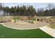 Community playground and recreational area with natural landscaping at 301 Beacon Dr, Pittsboro, NC 27312