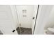 Modern shower featuring sleek glass enclosure and tiled walls with shower niche at 301 Beacon Dr, Pittsboro, NC 27312