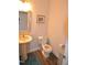 Powder room with pedestal sink and wood look floors at 311 Silverhawk Ln, Durham, NC 27703