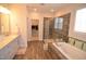 Bright primary bathroom featuring a glass-enclosed shower, soaking tub, and double vanity at 311 Silverhawk Ln, Durham, NC 27703