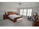 Spacious primary bedroom with tray ceiling, carpet, and large window with shutters at 311 Silverhawk Ln, Durham, NC 27703