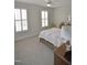Primary bedroom boasts neutral carpet, plantation shutters, ceiling fan and ensuite bath at 311 Silverhawk Ln, Durham, NC 27703