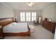 Bright main bedroom boasts a trey ceiling, shutters, and lots of space at 311 Silverhawk Ln, Durham, NC 27703