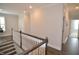 Bright hallway with hardwood floors and white trim, leading to bedrooms at 311 Silverhawk Ln, Durham, NC 27703