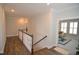 Upstairs hallway boasts hardwood floors and classic white trim and a view to the sunroom at 311 Silverhawk Ln, Durham, NC 27703