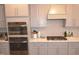 Well-appointed kitchen with stainless steel appliances, granite countertops, and custom cabinetry at 311 Silverhawk Ln, Durham, NC 27703