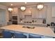 Bright and airy kitchen featuring a large island with seating and stainless steel appliances at 311 Silverhawk Ln, Durham, NC 27703