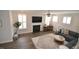 Spacious living room with hardwood floors, a fireplace, and comfortable seating at 311 Silverhawk Ln, Durham, NC 27703