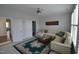 Cozy sitting room with white couch, carpet, and shutters on the windows at 311 Silverhawk Ln, Durham, NC 27703