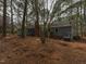 Backyard view of home with mature trees and landscaping at 314 Mill Creek Dr, Fuquay Varina, NC 27526