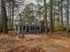 Backyard featuring patio surrounded by mature trees at 314 Mill Creek Dr, Fuquay Varina, NC 27526