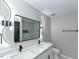 Modern bathroom featuring double sink vanity with quartz countertops and LED light fixtures at 314 Mill Creek Dr, Fuquay Varina, NC 27526