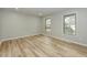 Bright bedroom with two windows and light wood floors, offering a clean and simple design at 314 Mill Creek Dr, Fuquay Varina, NC 27526