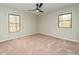 Comfortable bedroom with carpet, two windows, and neutral walls, creating a cozy retreat at 314 Mill Creek Dr, Fuquay Varina, NC 27526