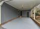 Spacious carport area with painted concrete flooring and access to side entry door at 314 Mill Creek Dr, Fuquay Varina, NC 27526