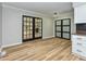 Well-lit dining area with new floors and black framed glass doors leading to other rooms at 314 Mill Creek Dr, Fuquay Varina, NC 27526