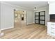 Bright dining area featuring wood floors, glass doors, and an open view to the living room with front door at 314 Mill Creek Dr, Fuquay Varina, NC 27526