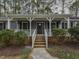 Home's entrance featuring a pathway leading up to the front porch and stylish exterior lighting at 314 Mill Creek Dr, Fuquay Varina, NC 27526