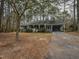 Inviting single-story house featuring a covered front porch, mature trees, and a private driveway at 314 Mill Creek Dr, Fuquay Varina, NC 27526