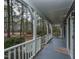 Inviting front porch with white railings and a view of the surrounding wooded area at 314 Mill Creek Dr, Fuquay Varina, NC 27526