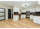 Renovated kitchen featuring white cabinets, stainless steel appliances, and black tile backsplash at 314 Mill Creek Dr, Fuquay Varina, NC 27526