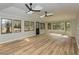 Bright living room featuring light wood floors, modern ceiling fans, and plenty of natural light at 314 Mill Creek Dr, Fuquay Varina, NC 27526