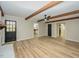 Spacious living room featuring wood floors, modern ceiling fan, and access to other rooms at 314 Mill Creek Dr, Fuquay Varina, NC 27526