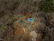 Aerial view highlighting the home and its pool with mature trees surrounding the property at 3217 Stoneyford Ct, Raleigh, NC 27603