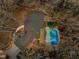 Aerial view of a home with a swimming pool, nestled among mature trees offering privacy at 3217 Stoneyford Ct, Raleigh, NC 27603